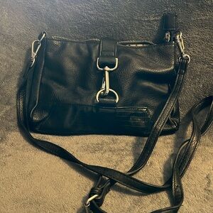 Crossbody purse. 3 inside pockets. 10” wide 6.5” tall. Ziptop with magnetic snap